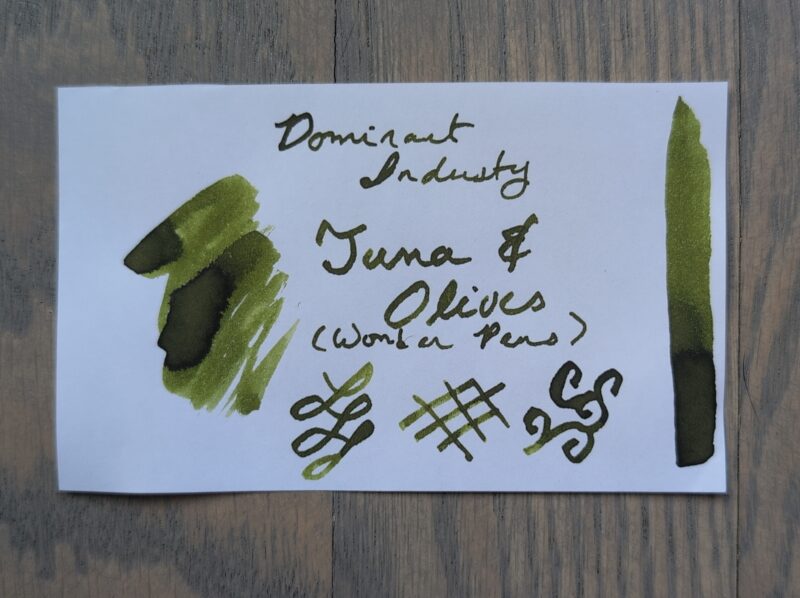 A swatch of Dominant Industry Tuna & Olives, an exclusive fountain pen ink for Wonder Pens. It's an olive green standard ink.
