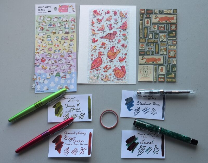 June 2026 Stationery choices: sticker sheets featuring birds and foxes and forest-y motifs, 4 pens and inks (all described further in the post)