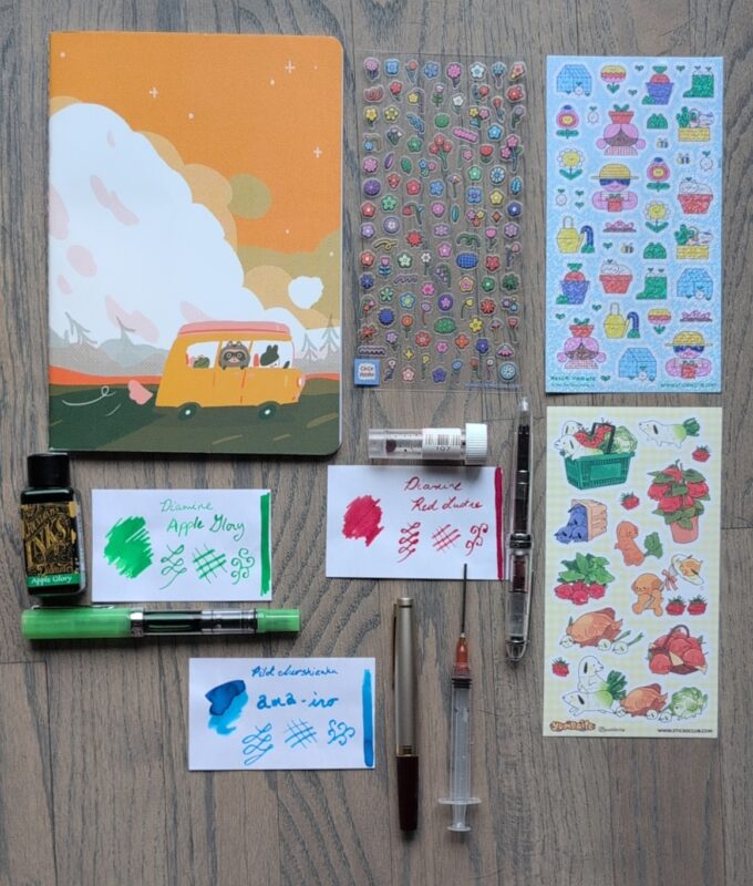 A new A5 notbook with a camper van vibe, three sticker sheets, three pens and inks. (Described in more detail in the post)