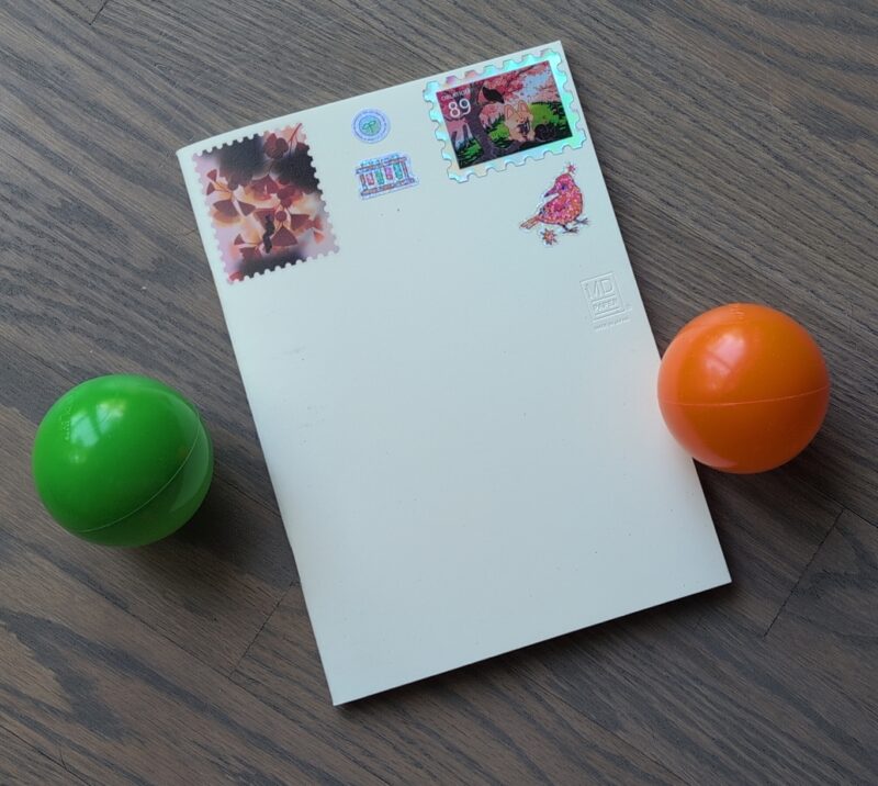 MD notebook with stickers on the top of the cover.