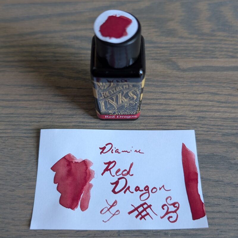 Diamine Red Dragon fountain pen ink bottle and swatch.